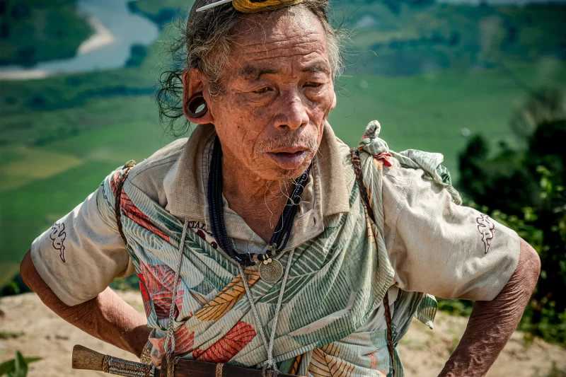 A Tribal Man with a Machete, Kappa Tee, and 1916 Indian Rupee Coin